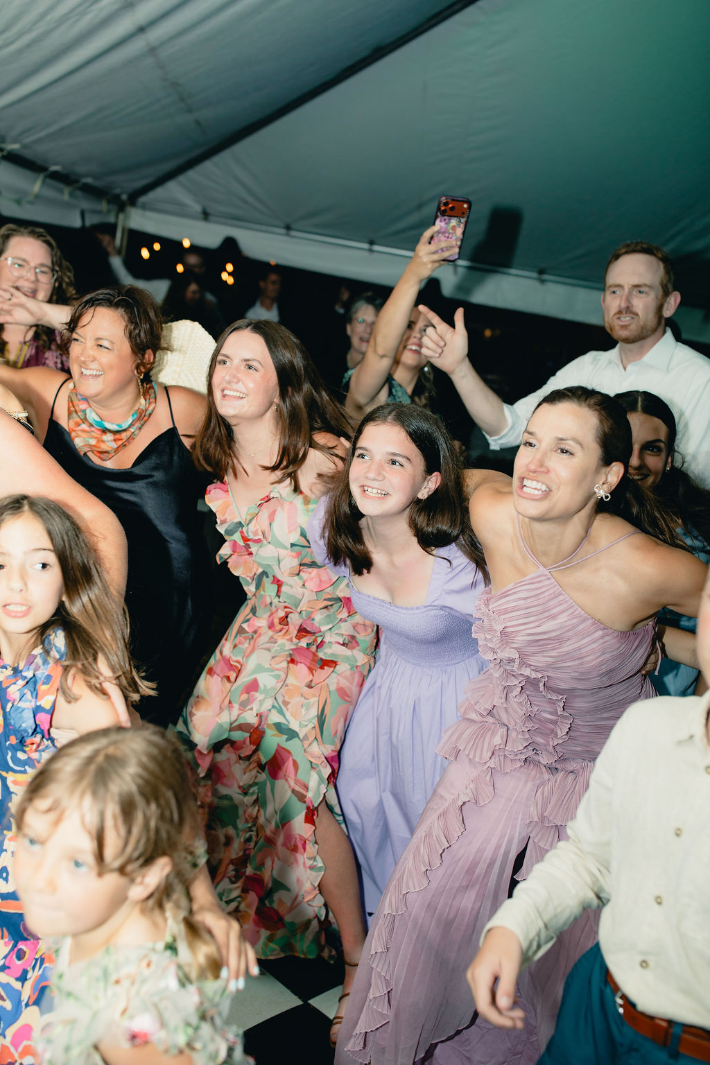 Wedding guests raising their hands and dancing