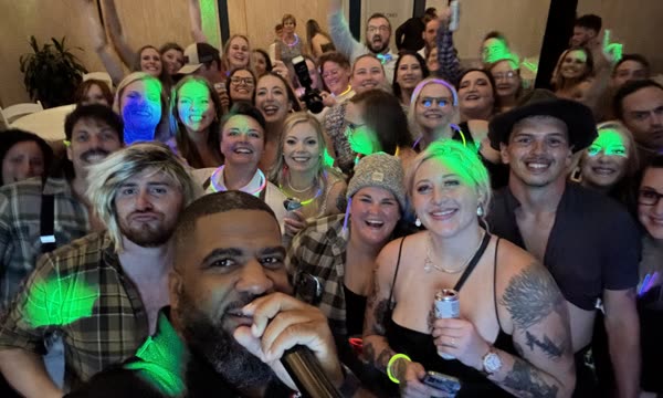 A packed dance floor crowded around the microphone.