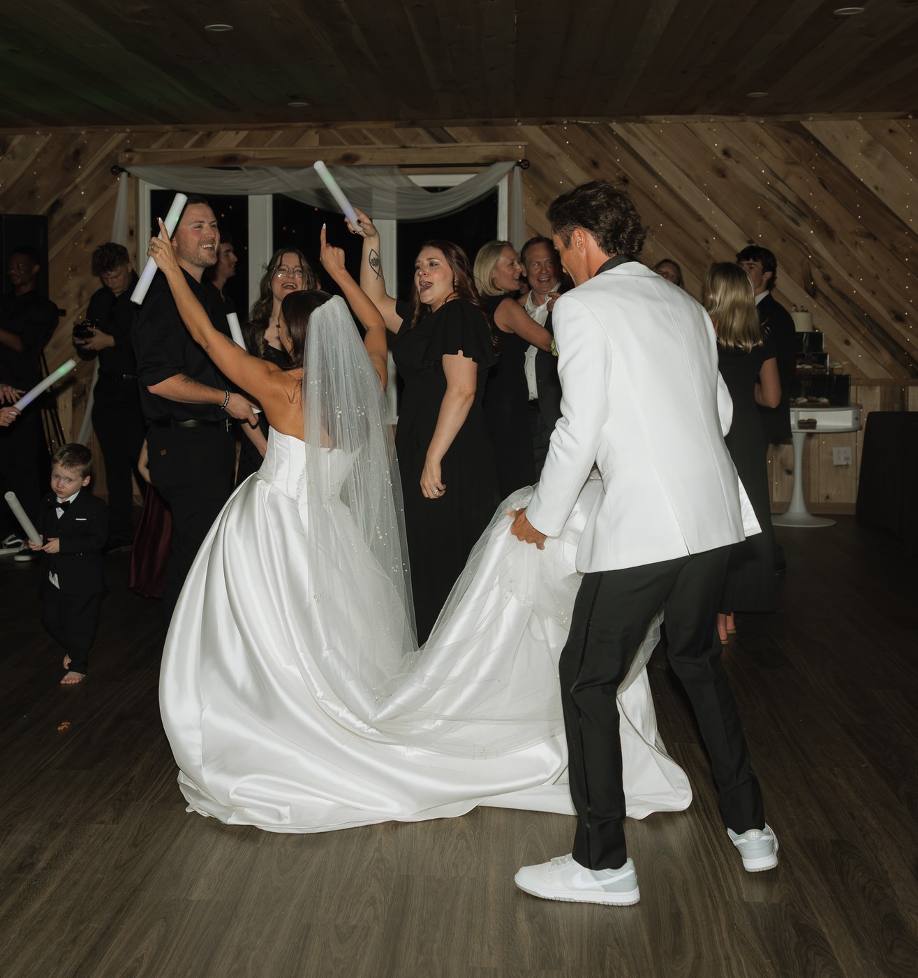 A bride and groom celebrating on the dance floor.